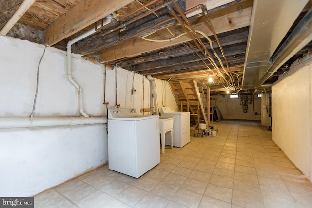 unfinished below grade area featuring independent washer and dryer