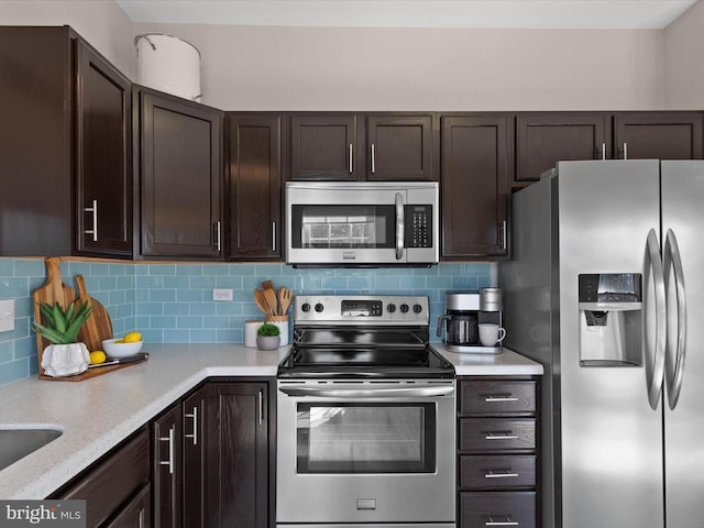 kitchen featuring light countertops, dark brown cabinets, tasteful backsplash, and stainless steel appliances