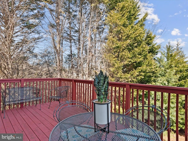 wooden terrace with outdoor dining area