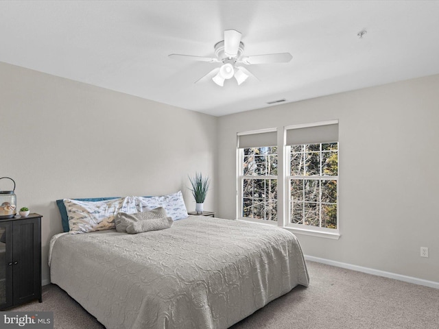 bedroom with visible vents, carpet, baseboards, and ceiling fan