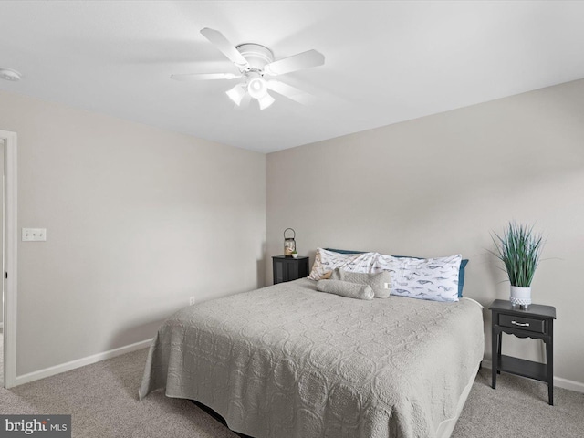 carpeted bedroom with baseboards and a ceiling fan