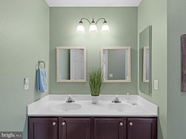 bathroom featuring a sink and double vanity