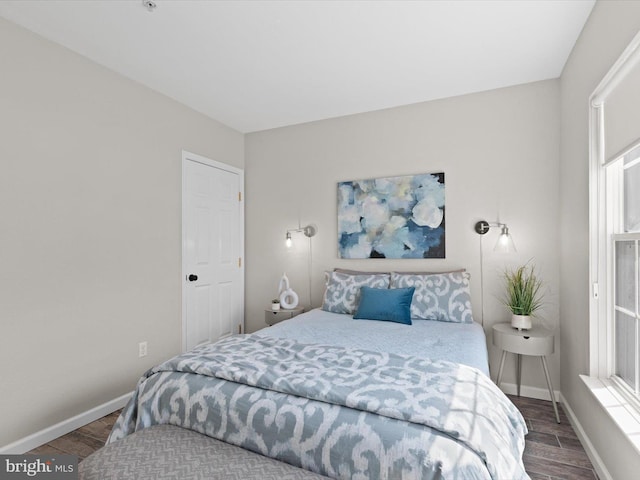 bedroom with baseboards and wood tiled floor