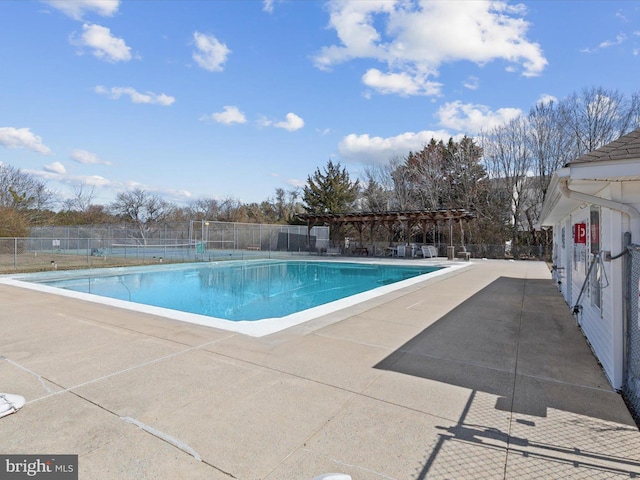 community pool with a patio, fence, and a pergola