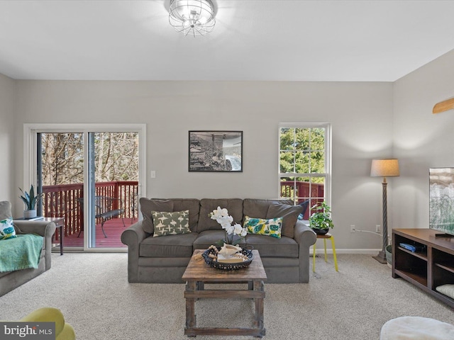 carpeted living area featuring baseboards