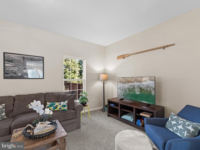 carpeted living area featuring baseboards