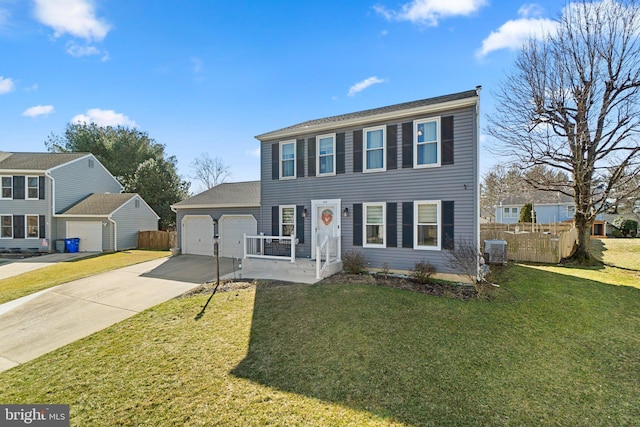 colonial inspired home featuring an attached garage, fence, driveway, and central AC