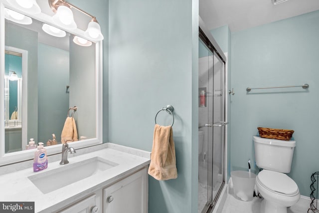 full bath with vanity, toilet, and a shower stall