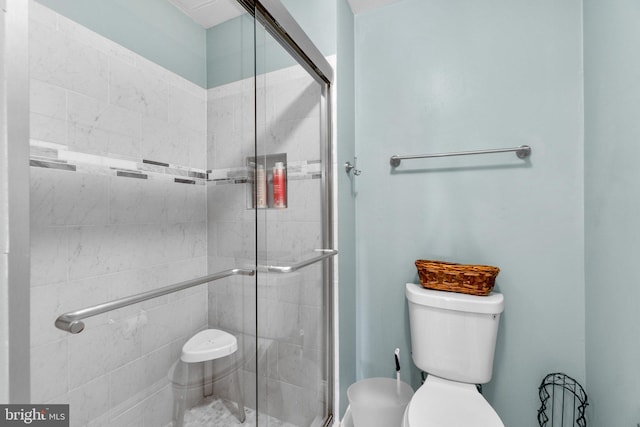 full bath featuring a shower stall and toilet