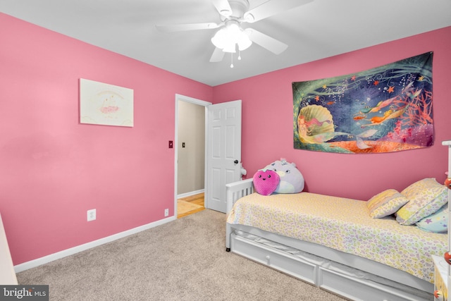 carpeted bedroom with a ceiling fan and baseboards