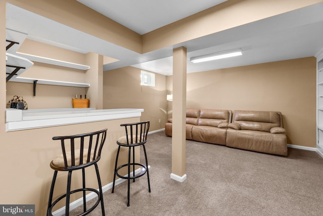 bar with a dry bar, carpet flooring, and baseboards