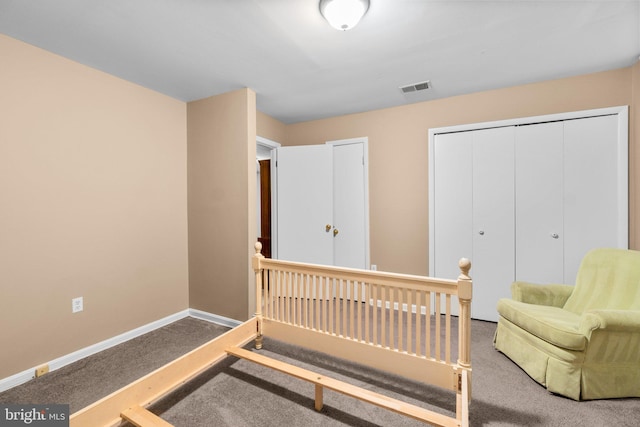 bedroom with a closet, visible vents, carpet, and baseboards