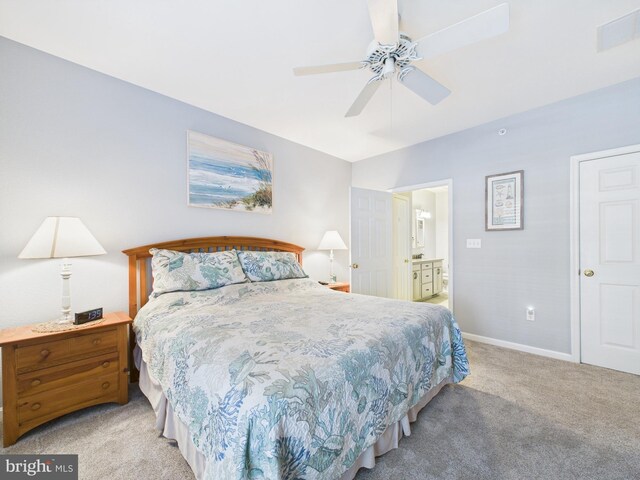 carpeted bedroom featuring a ceiling fan, connected bathroom, visible vents, and baseboards