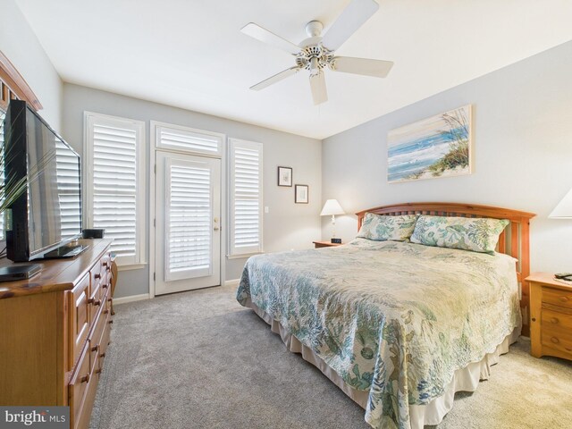 bedroom with light carpet, access to outside, and a ceiling fan