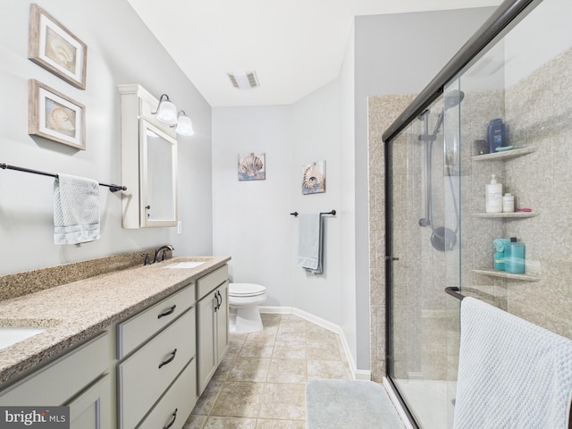 full bathroom featuring double vanity, toilet, a stall shower, a sink, and baseboards