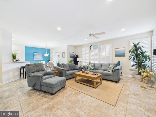 tiled living room featuring a ceiling fan, recessed lighting, and baseboards