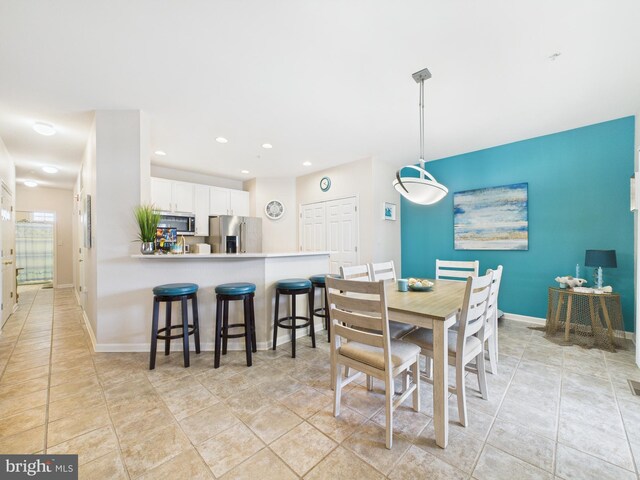 dining area featuring light tile patterned floors, baseboards, and recessed lighting