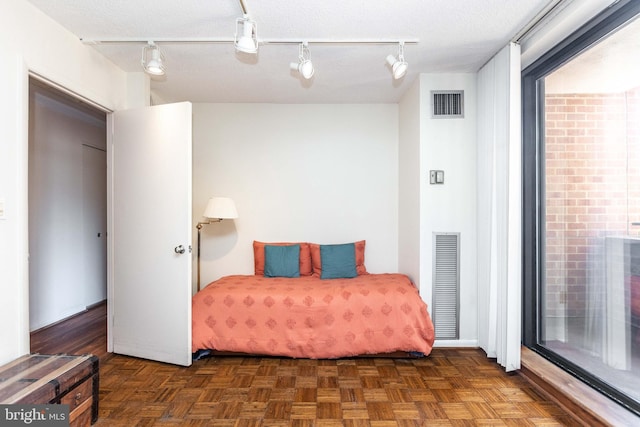 bedroom featuring visible vents and a textured ceiling