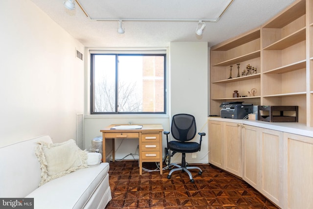 home office featuring visible vents and a textured ceiling