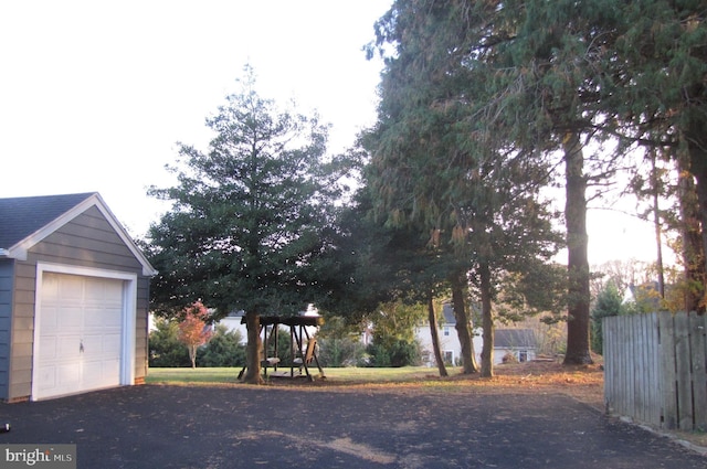 exterior space with aphalt driveway and fence