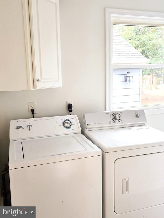 laundry area with cabinet space and independent washer and dryer