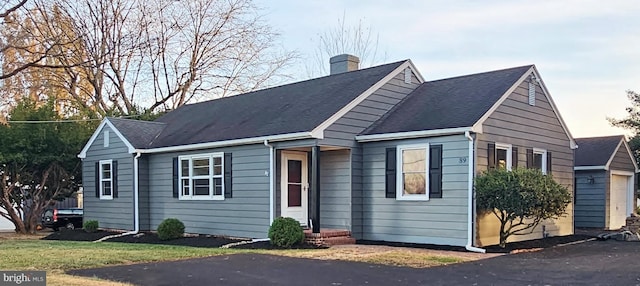 view of front of house with a garage and a chimney