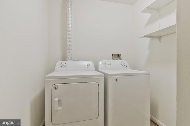 laundry room featuring laundry area, baseboards, and washer and dryer