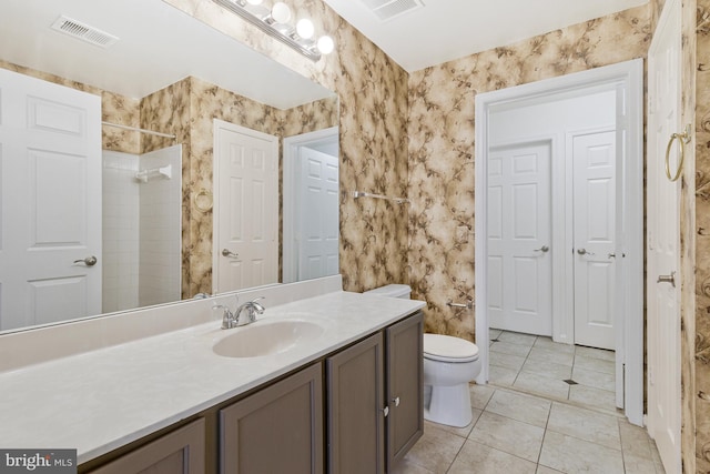 full bathroom with toilet, vanity, visible vents, a shower, and tile patterned floors