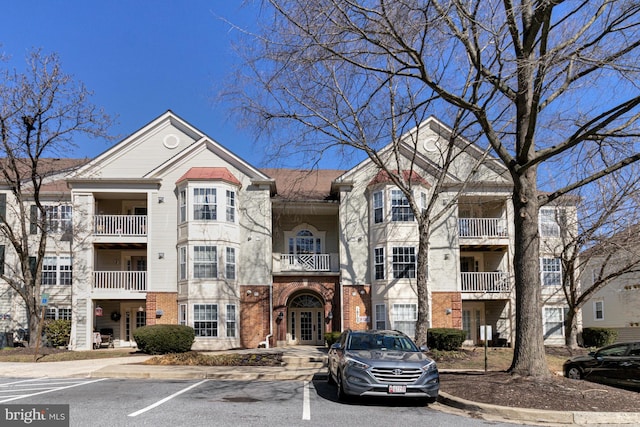 view of building exterior with uncovered parking