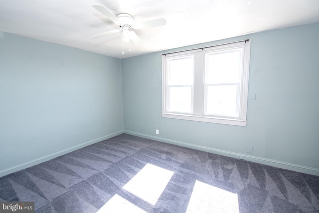 empty room with a ceiling fan, carpet flooring, and baseboards