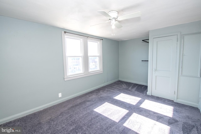 unfurnished bedroom with carpet, a ceiling fan, and baseboards