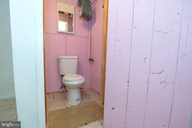 bathroom with toilet and tile patterned flooring