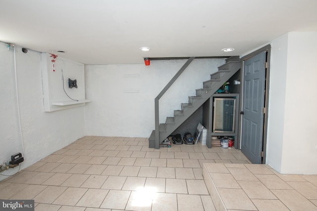 below grade area with recessed lighting, stairs, and tile patterned floors