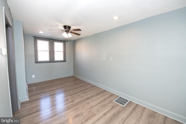 empty room with recessed lighting, visible vents, light wood-style floors, a ceiling fan, and baseboards