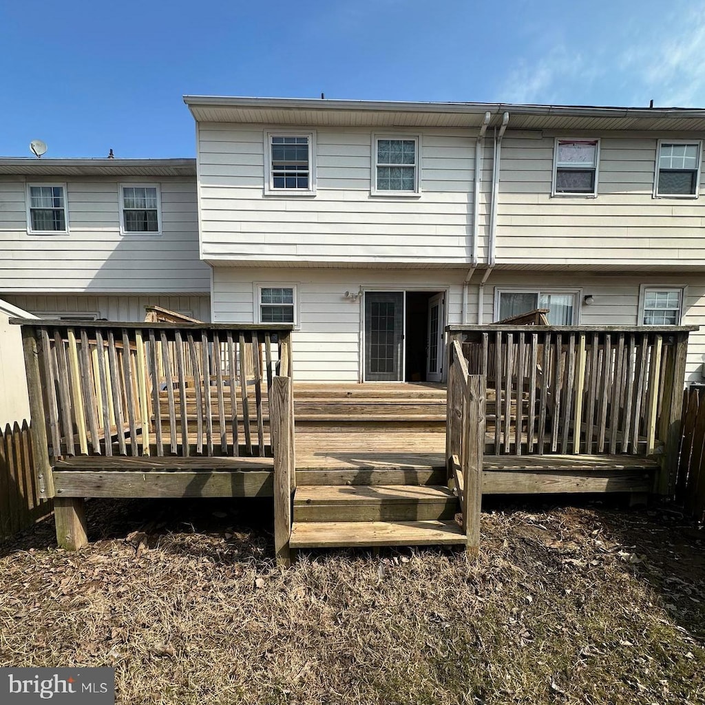 rear view of house featuring a wooden deck