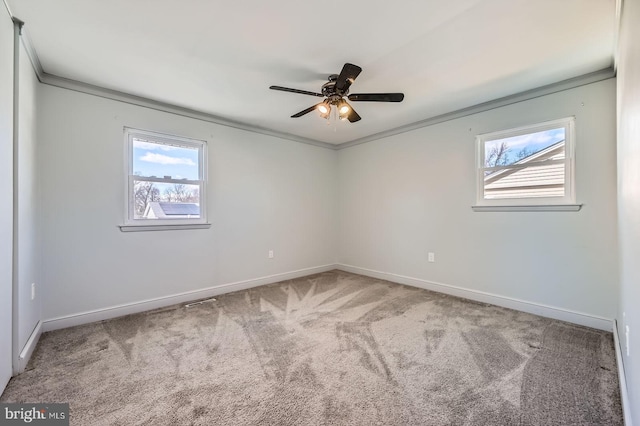 unfurnished room featuring a ceiling fan, baseboards, carpet floors, and ornamental molding