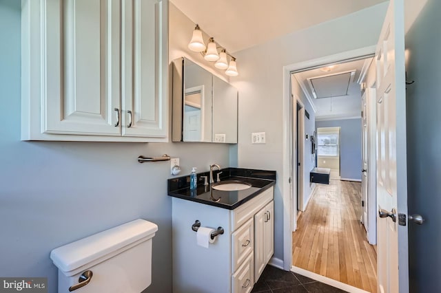 bathroom with baseboards, toilet, vanity, and tile patterned flooring