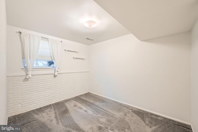 unfurnished room featuring visible vents and carpet