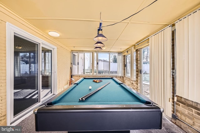 rec room featuring pool table, carpet, and brick wall