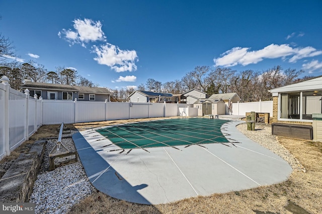 view of pool with an outbuilding, a fenced backyard, a residential view, a storage shed, and a patio area