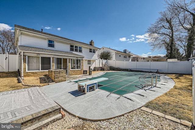 view of swimming pool featuring a fenced in pool, a fenced backyard, and a patio area