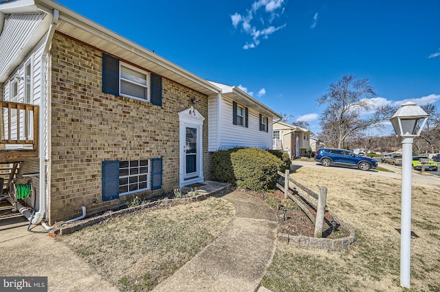 view of side of home featuring brick siding