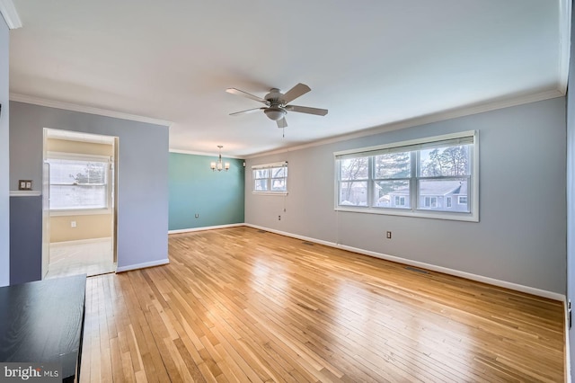 spare room with visible vents, baseboards, light wood finished floors, ornamental molding, and ceiling fan with notable chandelier