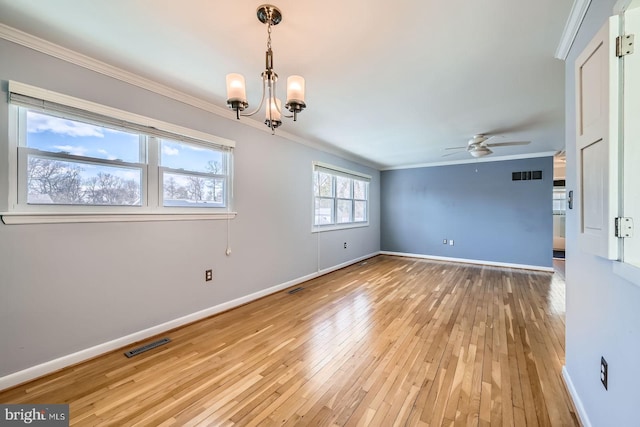 empty room with light wood-style flooring, baseboards, visible vents, and ornamental molding