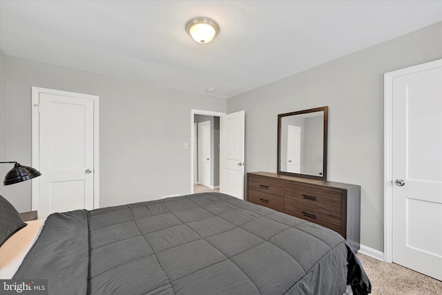 carpeted bedroom featuring baseboards