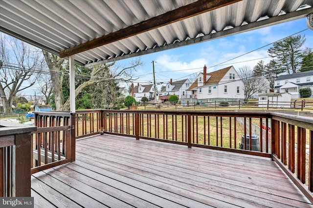 deck with a residential view, central AC unit, and fence