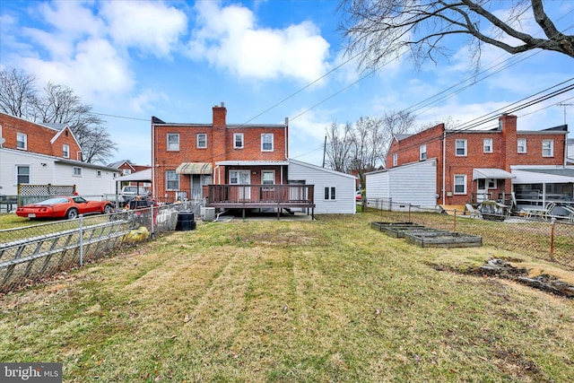 back of property featuring a lawn, a fenced backyard, a garden, brick siding, and a chimney