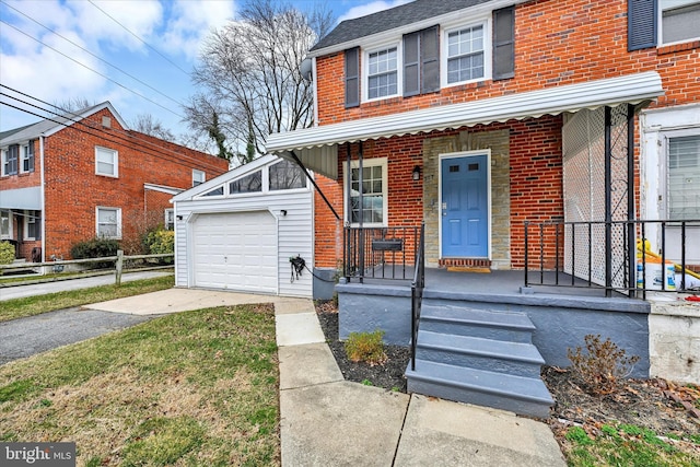 view of front facade featuring brick siding and driveway