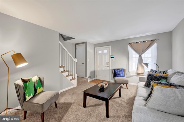 living area featuring stairway, baseboards, and carpet floors