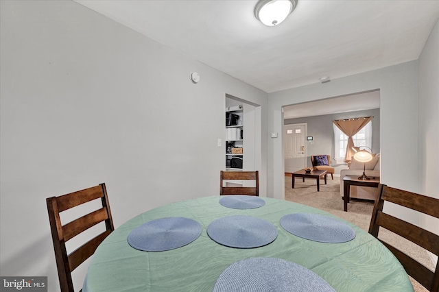 dining area with light colored carpet